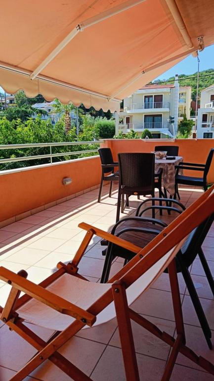 a patio with chairs and tables and an umbrella at Iraklitsa Teo Resort in Iraklitsa