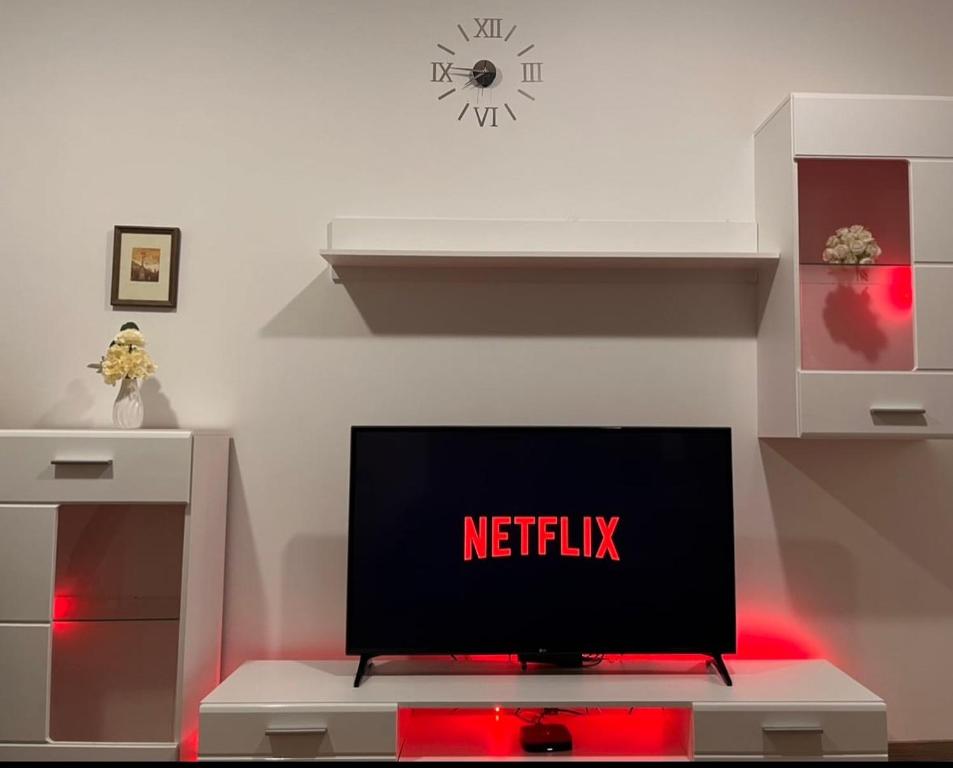a tv in a room with a netflix sign on it at Luxe Central Living Apartment in Debrecen