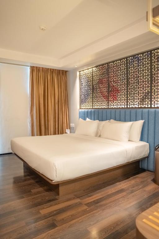 Postel nebo postele na pokoji v ubytování Akmani Hotel Jakarta