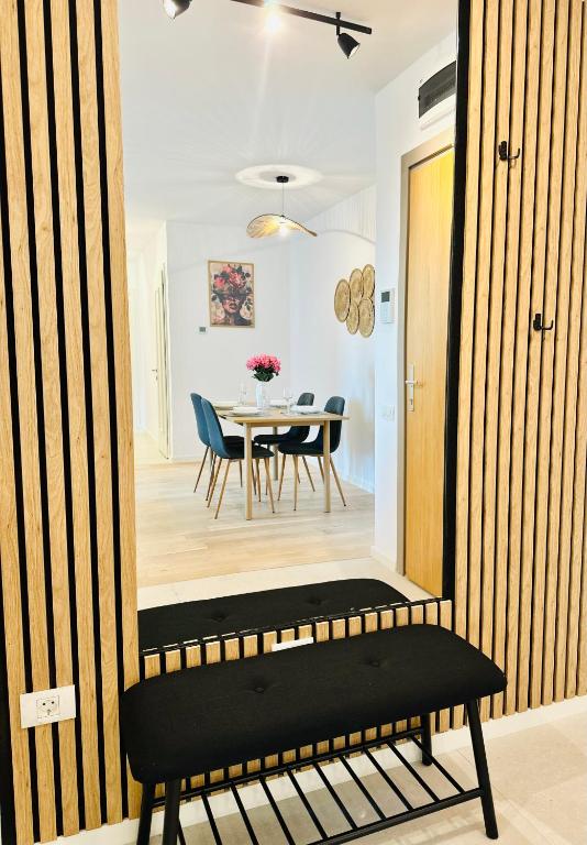 a mirror in a room with a table and chairs at Central Grand Apartment in Timişoara