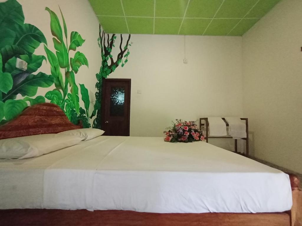 Postel nebo postele na pokoji v ubytování Keerthi Homestay