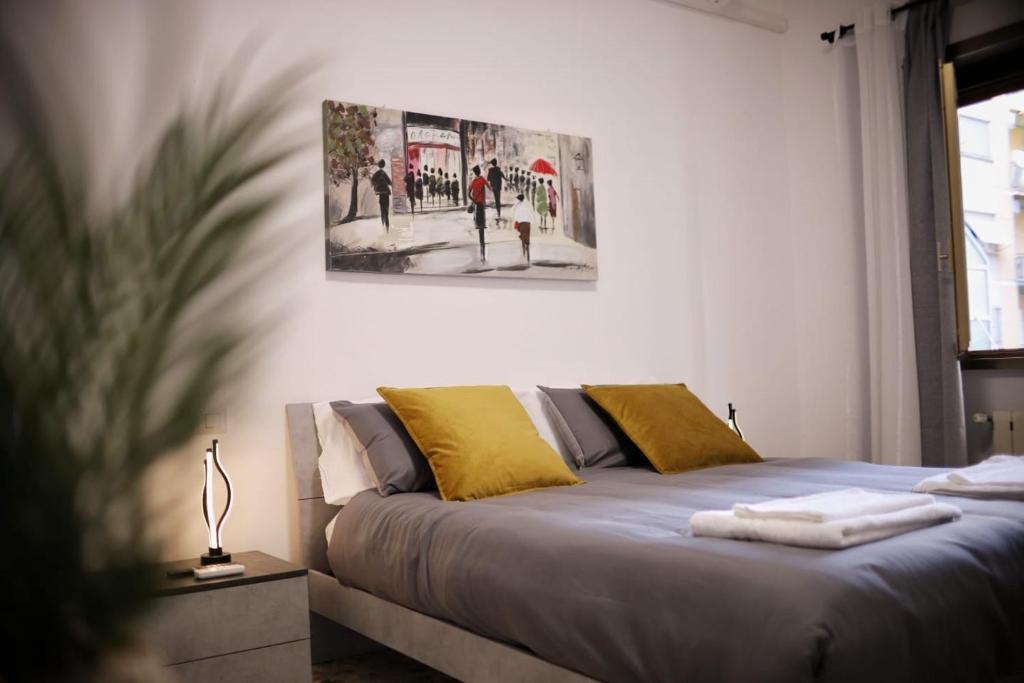 a bed in a bedroom with a painting on the wall at A Casa di Rocco in Rome
