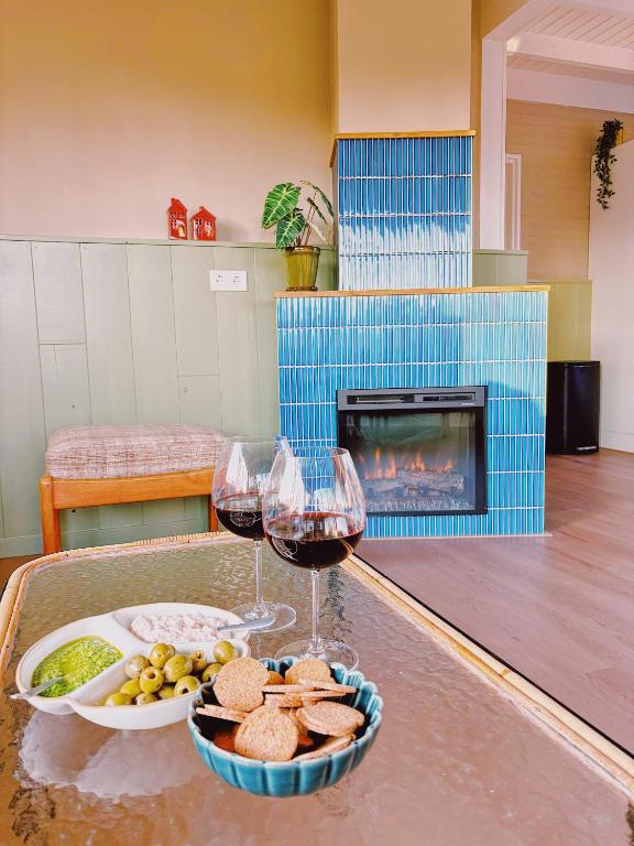 a table with two glasses of wine and a tray of food at Bungalow Doris met Hottub | 4 personen - Vakantiepark De Kremmer in Gasselte