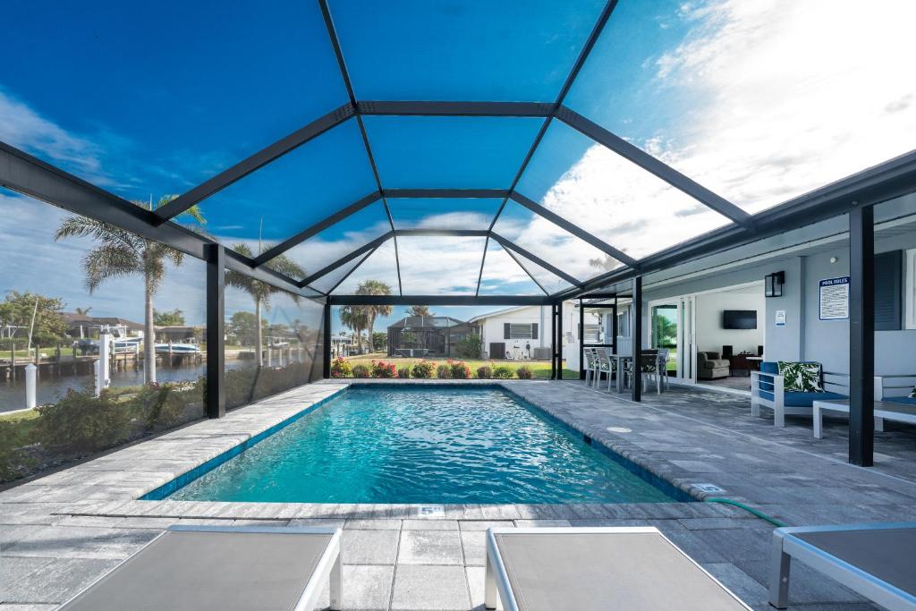 an indoor swimming pool with a glass ceiling at Villa Capri-Luxury Waterfront Punta Gorda, FL in Punta Gorda