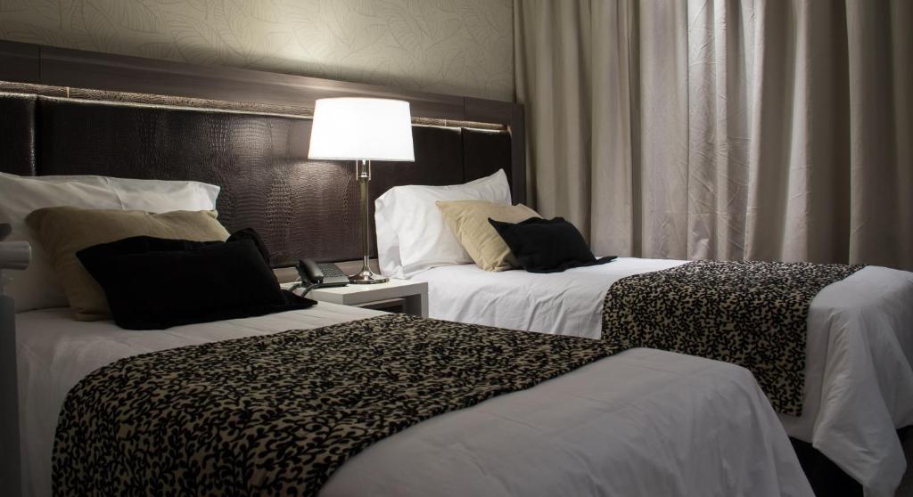 Postel nebo postele na pokoji v ubytování Amerian Río Gallegos Apart & Suites