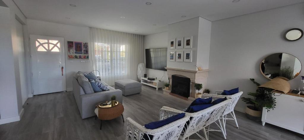 a living room with a couch and a fireplace at Beach House Altura in Altura