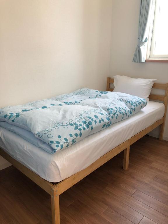 Postel nebo postele na pokoji v ubytování Aioi Lodge