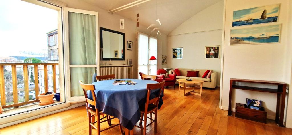 a living room with a table and chairs and a living room at Spacious apartment 4 people parking, bright in Aix-en-Provence