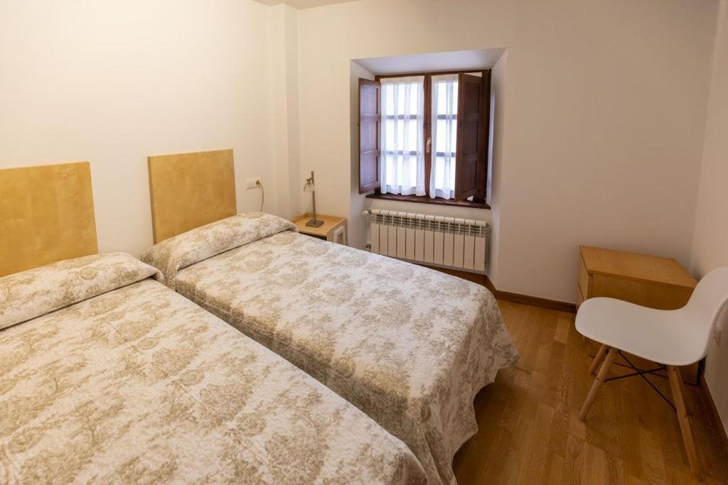 A bed or beds in a room at El Peregrino Llanes VUT