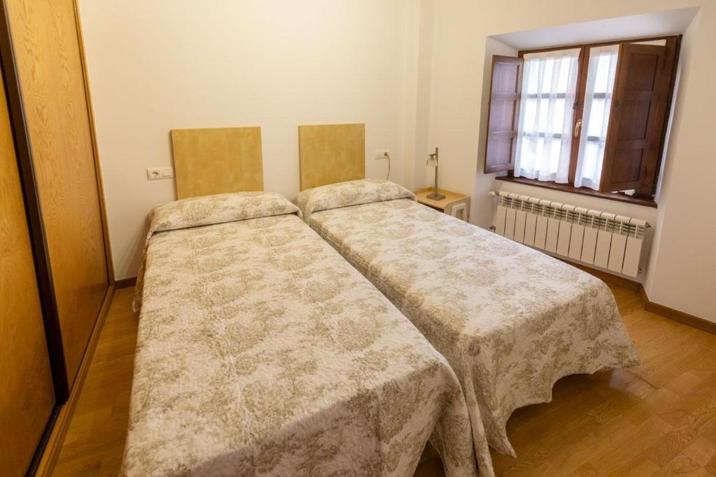 A bed or beds in a room at El Peregrino Llanes VUT