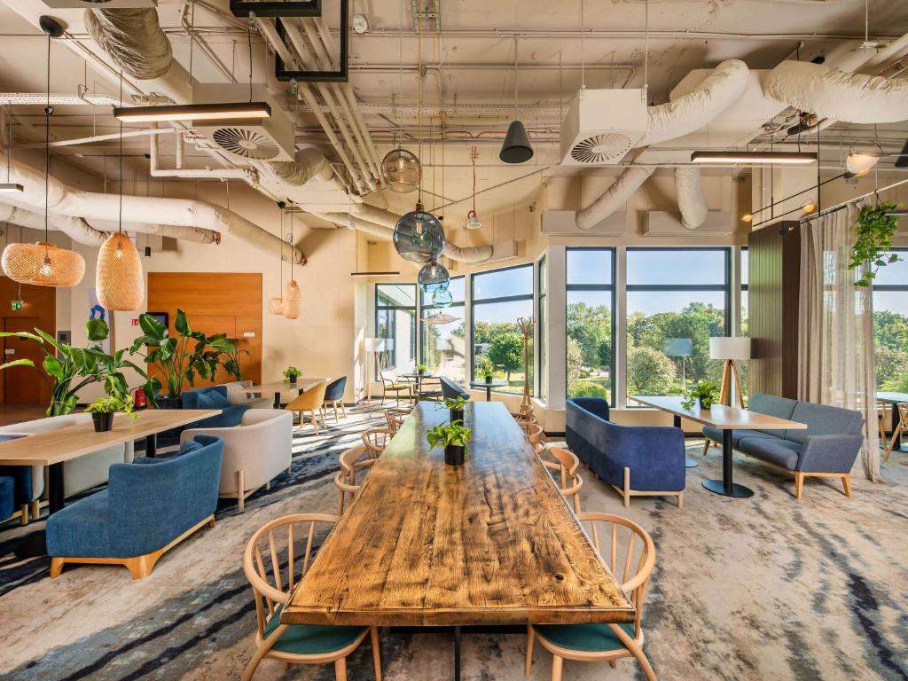a conference room with a wooden table and chairs at Novotel Gdańsk Marina in Gdańsk