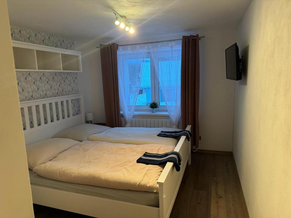 Postel nebo postele na pokoji v ubytování Apartmány Prostřední