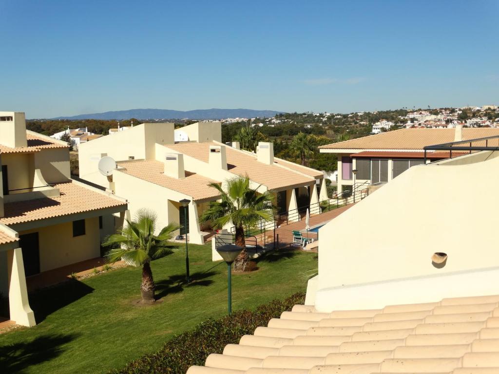 an aerial view of some houses and palm trees at Glenridge Resort By Albufeira Rental in Albufeira
