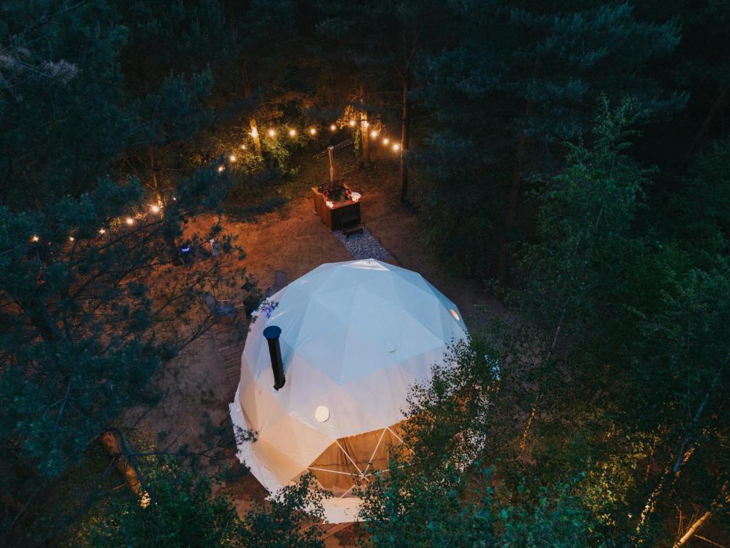an overhead view of a tent in the woods at night at Glamp Podróżnika i Marzyciela in Rogówko