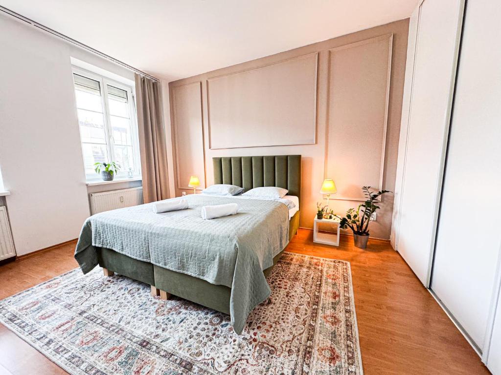 a bedroom with a bed and a rug at Gorgeous Central Apartment in Bratislava with Free Private Parking in Staré Mesto