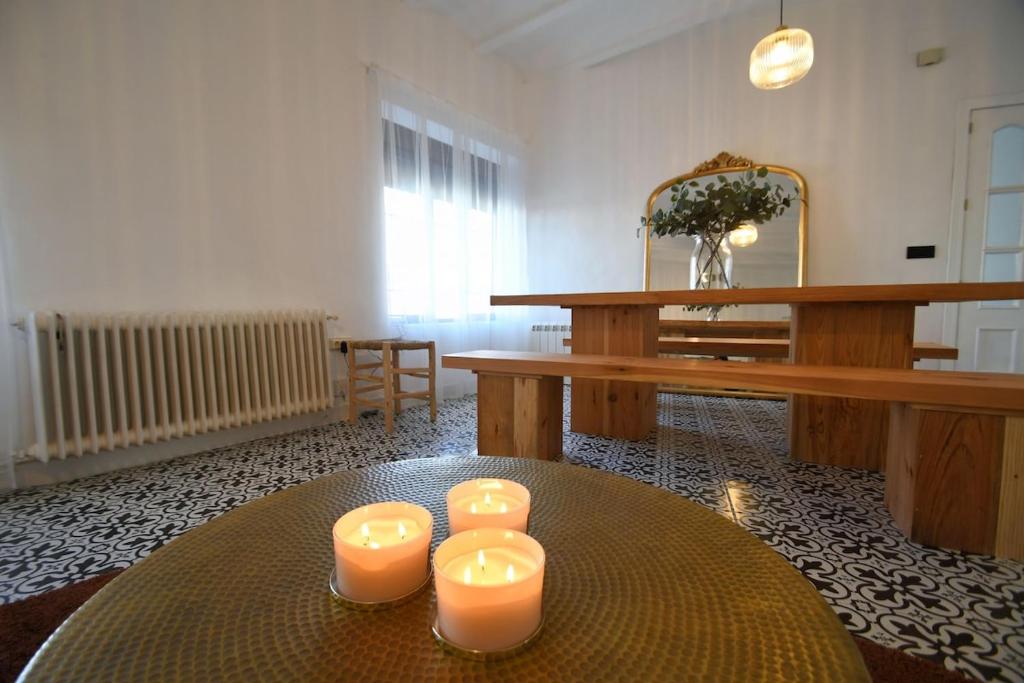 a room with a table with three candles on it at La Esquina del Castillo - A 15 min de Puy Du Fou in Orgaz