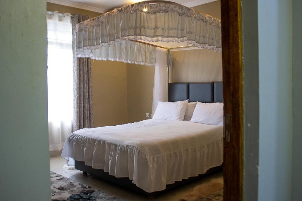 Postel nebo postele na pokoji v ubytování Crystal homes by chema