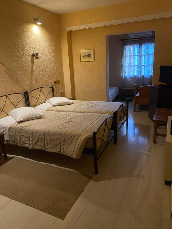 Postel nebo postele na pokoji v ubytování Olympic Hotel