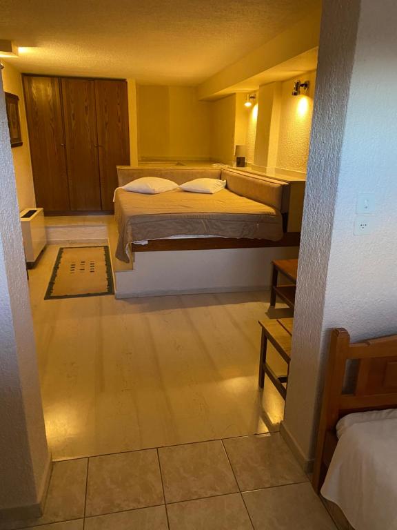 Postel nebo postele na pokoji v ubytování Olympic Hotel
