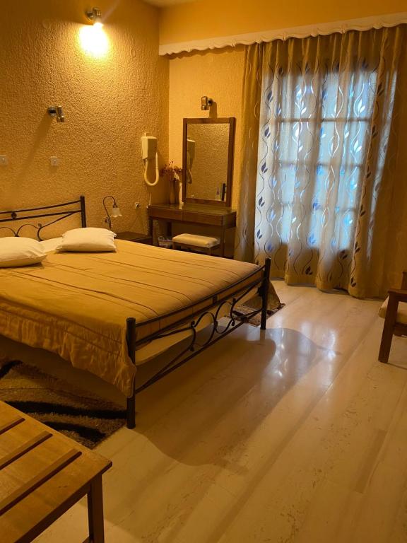 Postel nebo postele na pokoji v ubytování Olympic Hotel