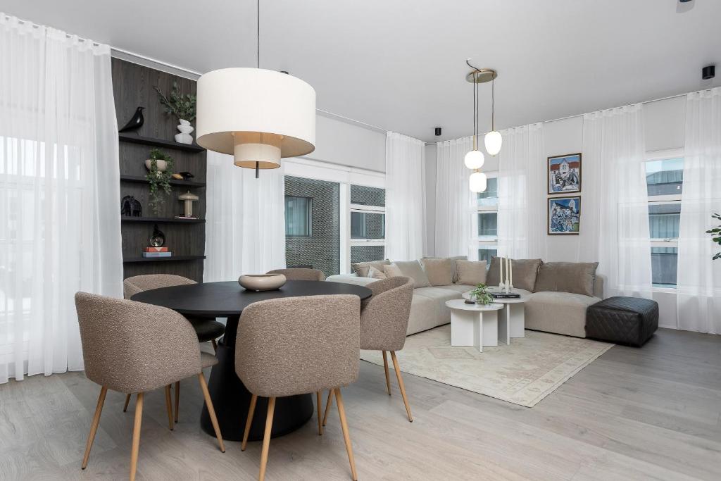 a living room with a table and a couch at Luxury Central Apartment in Reykjavík