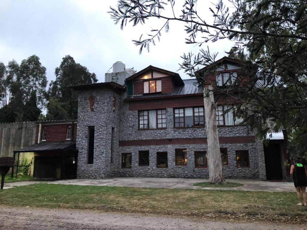 a large stone house with a tree in front of it at La Posada Encantada in Mar del Plata