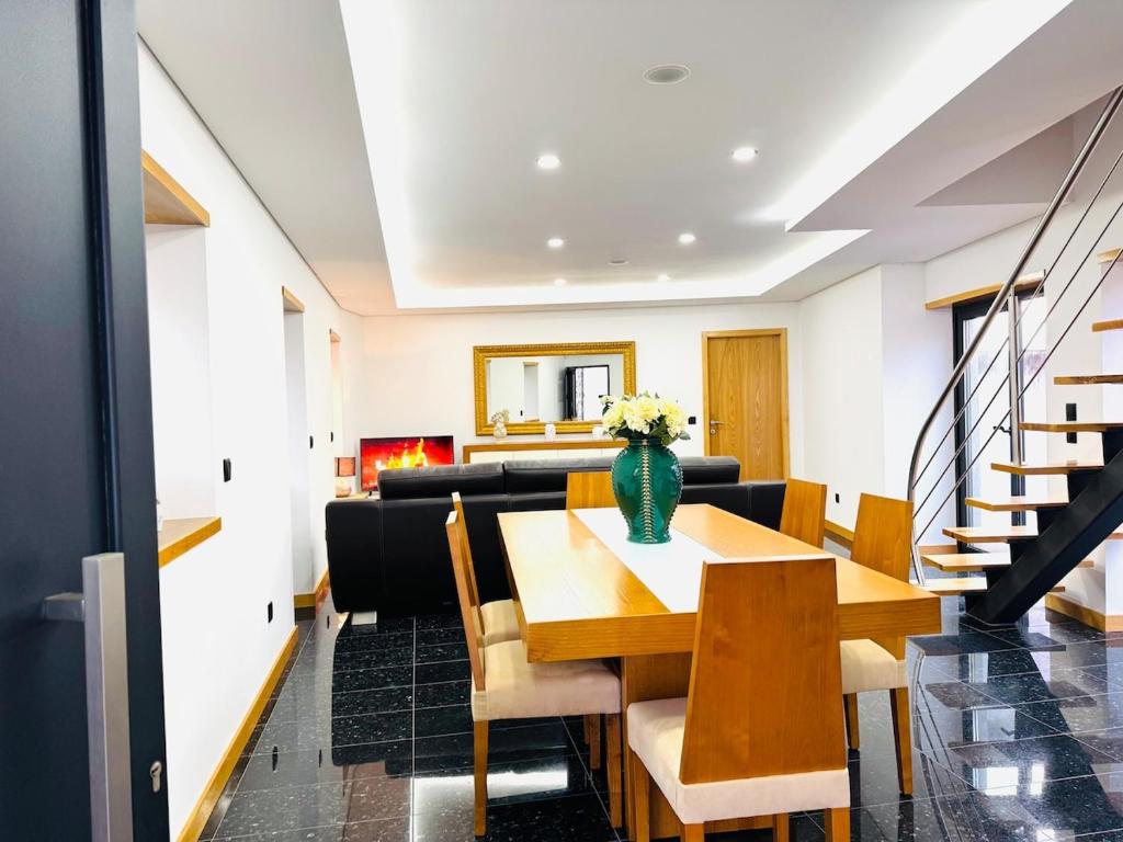 a dining room with a table and chairs at Golden Paradise in Esposende