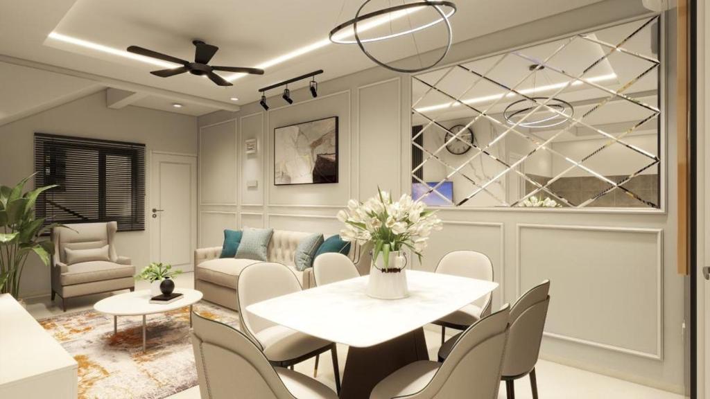 a dining room with a white table and chairs at Aleenz Residence in Kuala Terengganu