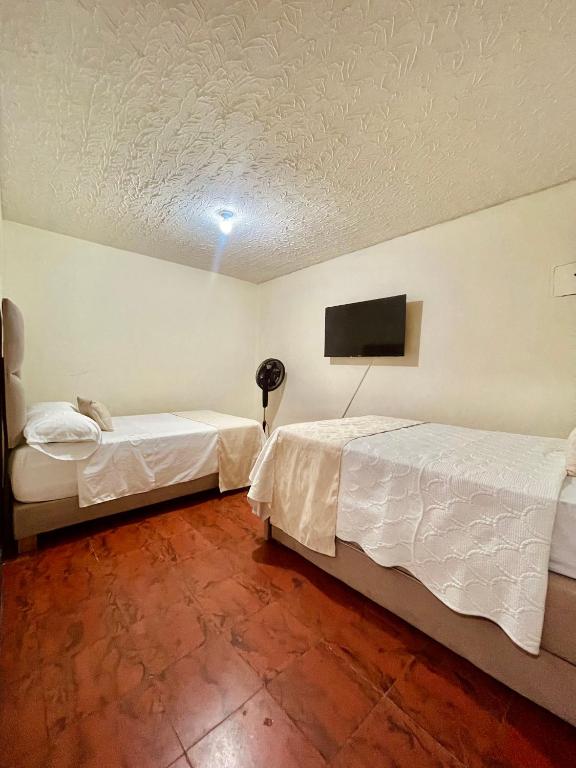 Postel nebo postele na pokoji v ubytování Hotel Casa Manta Cali