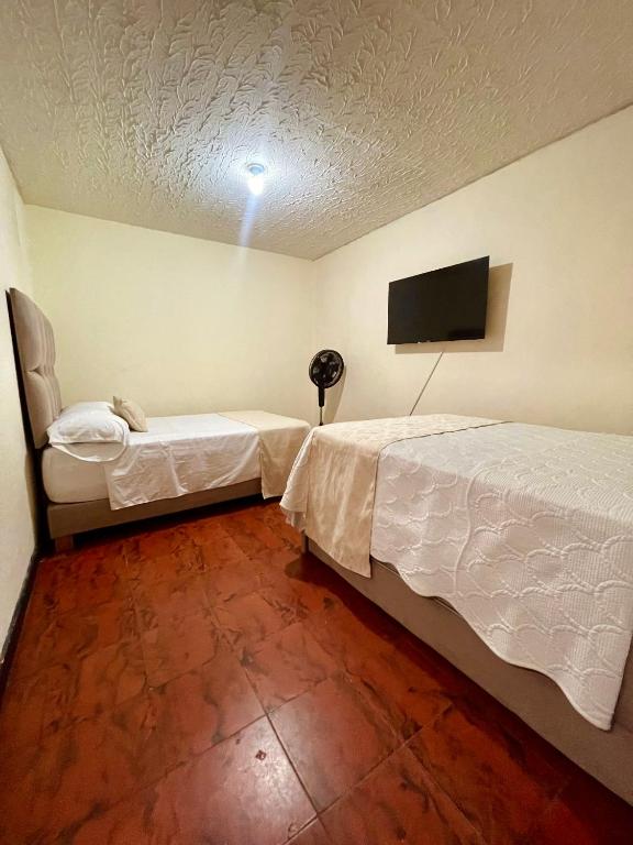 Postel nebo postele na pokoji v ubytování Hotel Casa Manta Cali