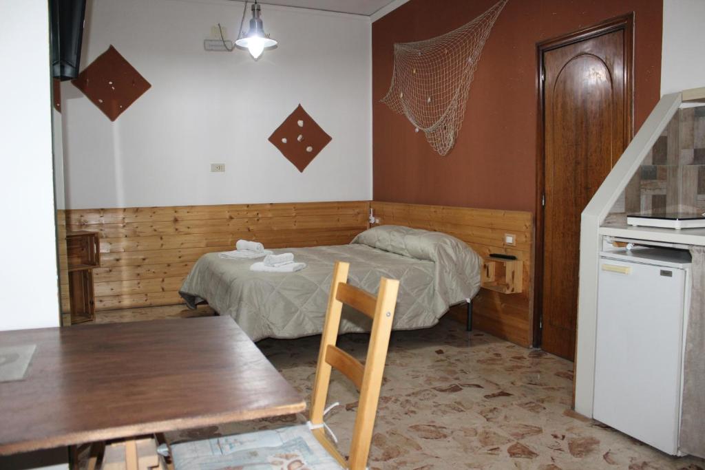 Postel nebo postele na pokoji v ubytování Nettuno Rooms