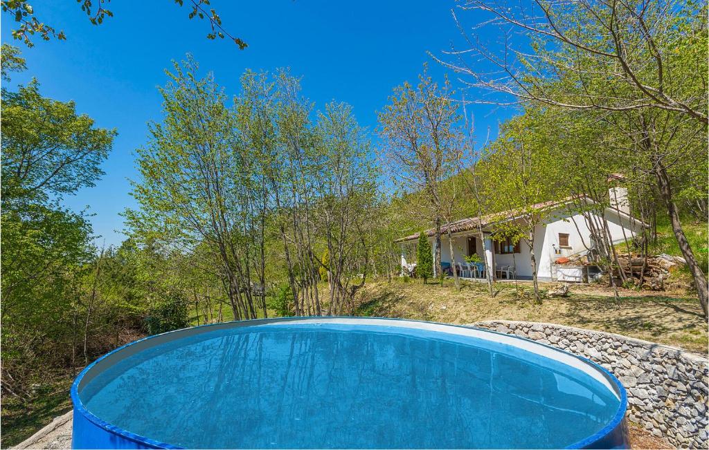 a swimming pool in front of a house at Two-Bedroom Holiday Home In Dolenja Vas in Dolenja Vas