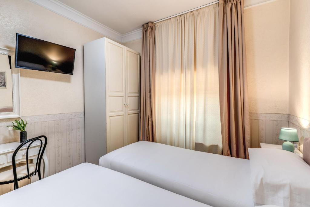 Postel nebo postele na pokoji v ubytování Hotel Orazia