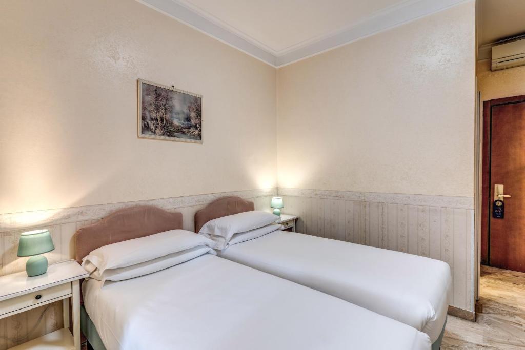 Postel nebo postele na pokoji v ubytování Hotel Orazia