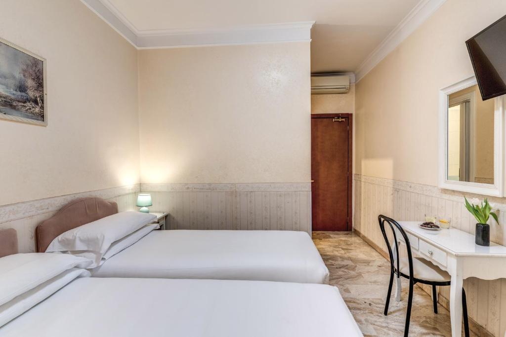 Postel nebo postele na pokoji v ubytování Hotel Orazia