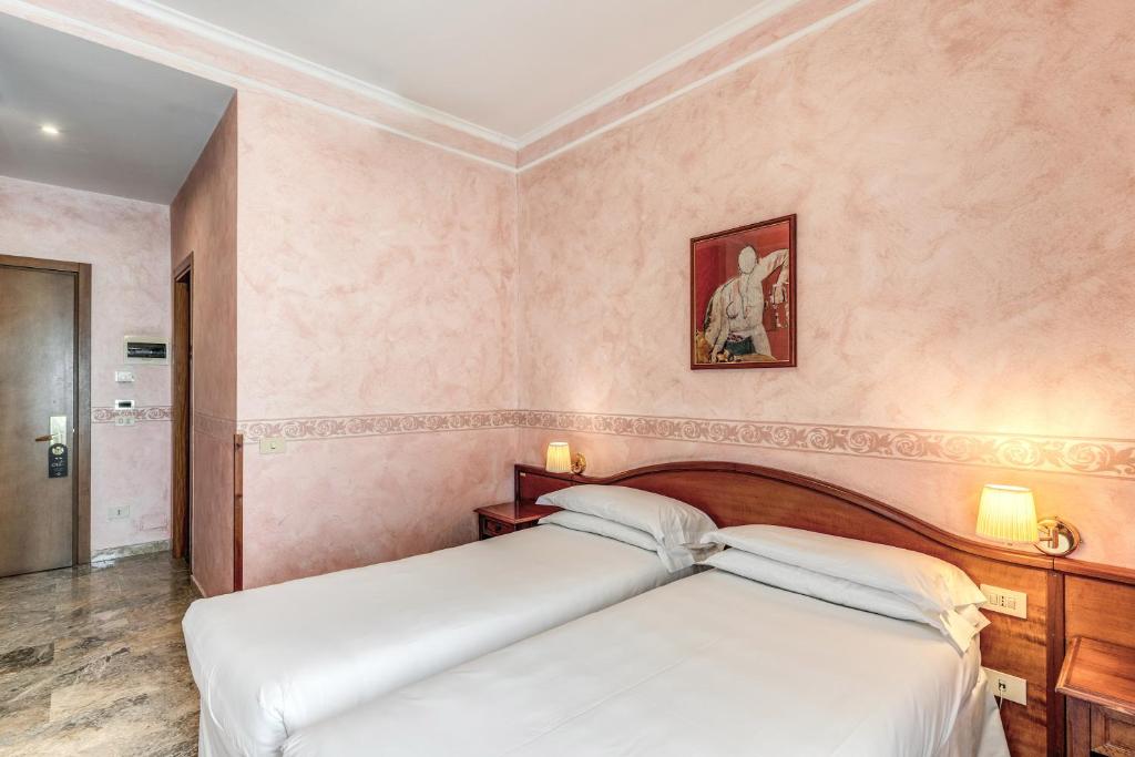 Postel nebo postele na pokoji v ubytování Hotel Orazia