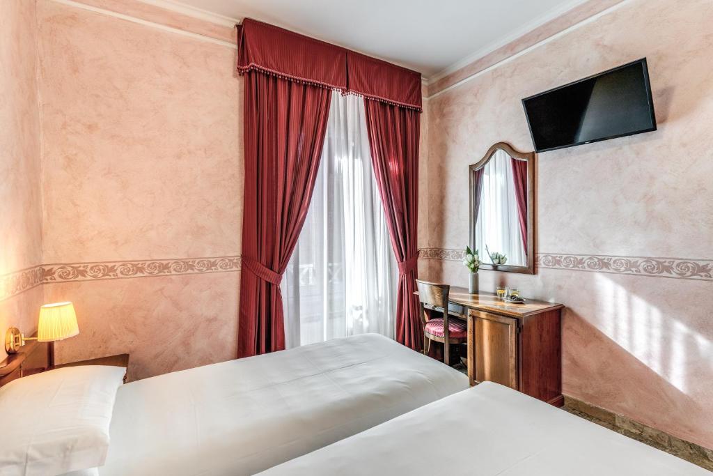 Postel nebo postele na pokoji v ubytování Hotel Orazia