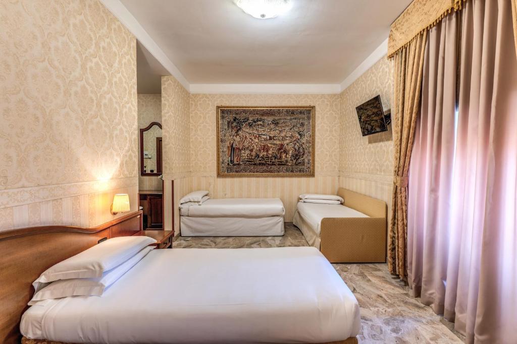 Postel nebo postele na pokoji v ubytování Hotel Orazia