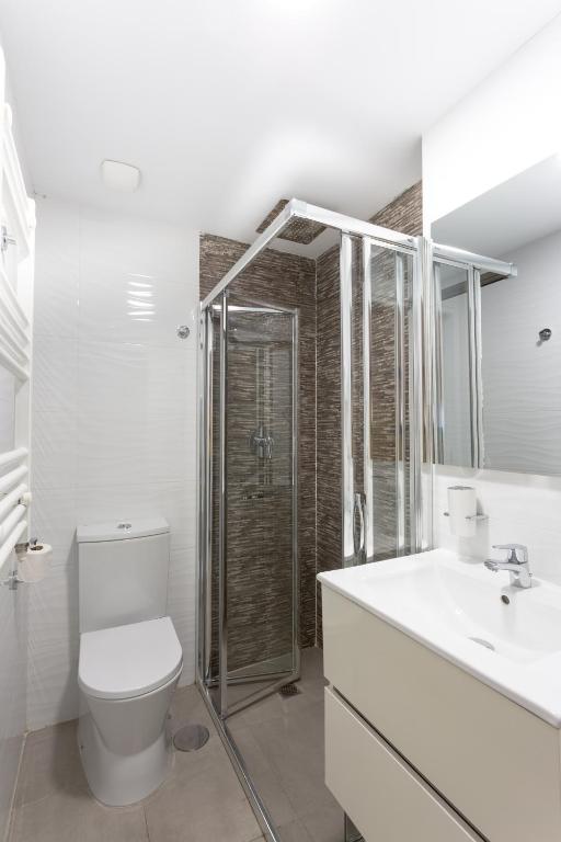a bathroom with a toilet and a sink and a shower at Calpe Beach in Calpe