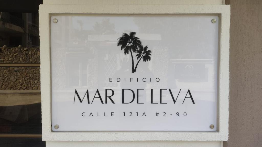 a sign for a marbella store with a palm tree on it at Edificio Mar de Leva in Santa Marta
