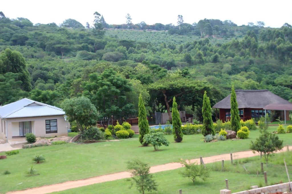 a view of a house and a yard at Emlanjeni Guest Lodge in White River