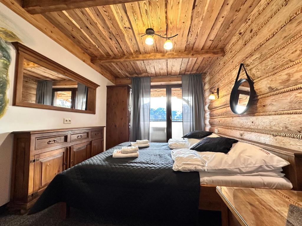 Posteľ alebo postele v izbe v ubytovaní Apartamenty z widokiem na Tatry Cztery Pory Roku