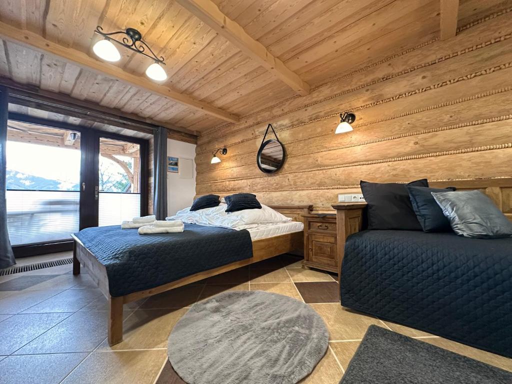 Posteľ alebo postele v izbe v ubytovaní Apartamenty z widokiem na Tatry Cztery Pory Roku