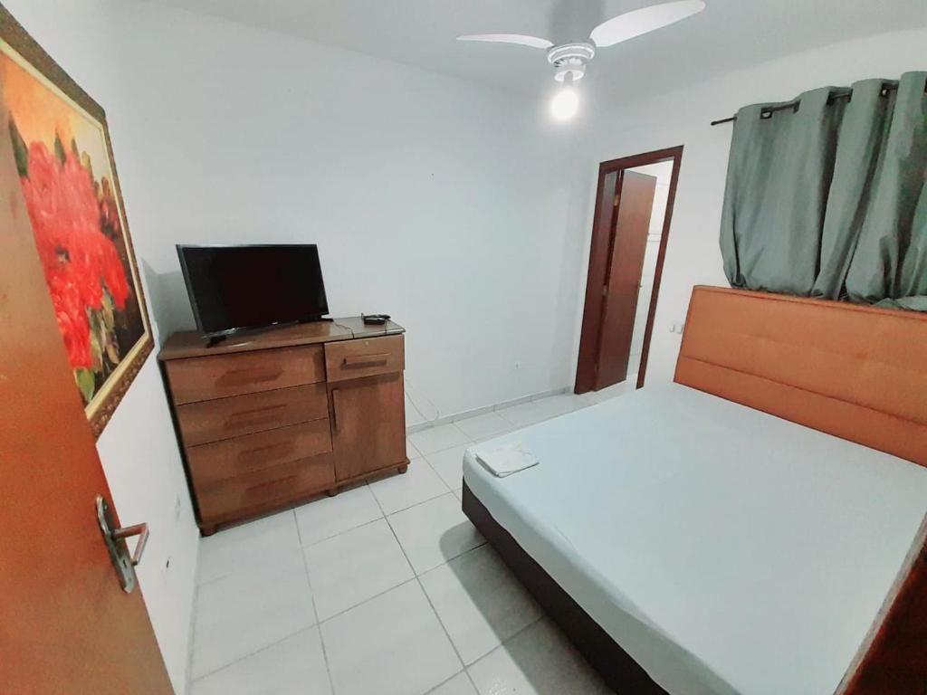 TV a/nebo společenská místnost v ubytování Casa em condomínio, com piscina, parquinho infantil, internet 500mb, ideal para família, garagem para 2 carros, com 2 quartos sendo 1 suíte, com Smart TV, 400m da PRAIA