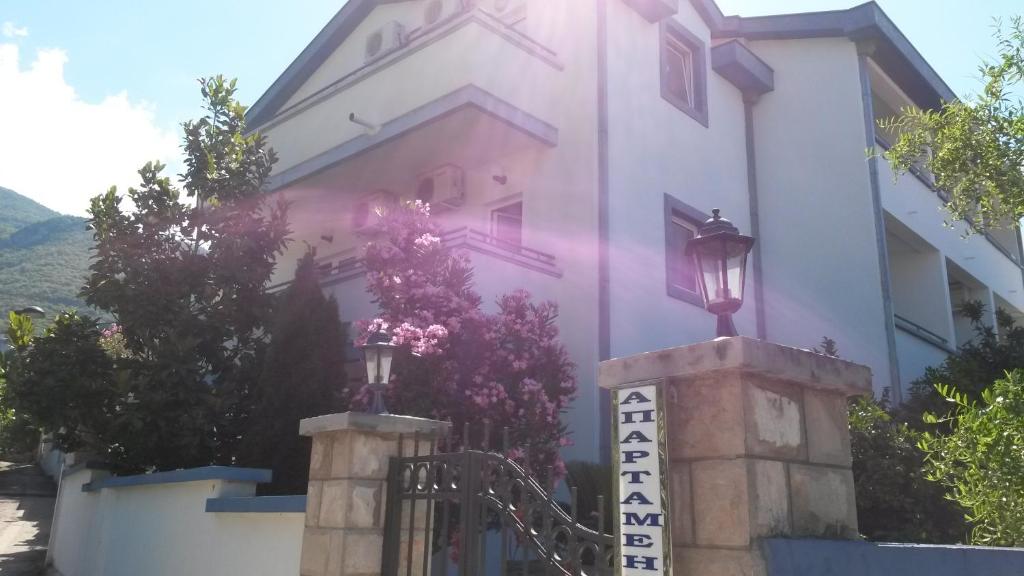 a white building with a sign in front of it at Apartments Becici in Budva