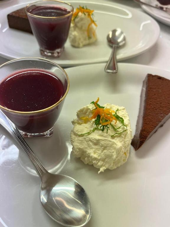 a plate of food with a bowl of soup and a spoon at Bryn Noddfa in Morfa Nefyn