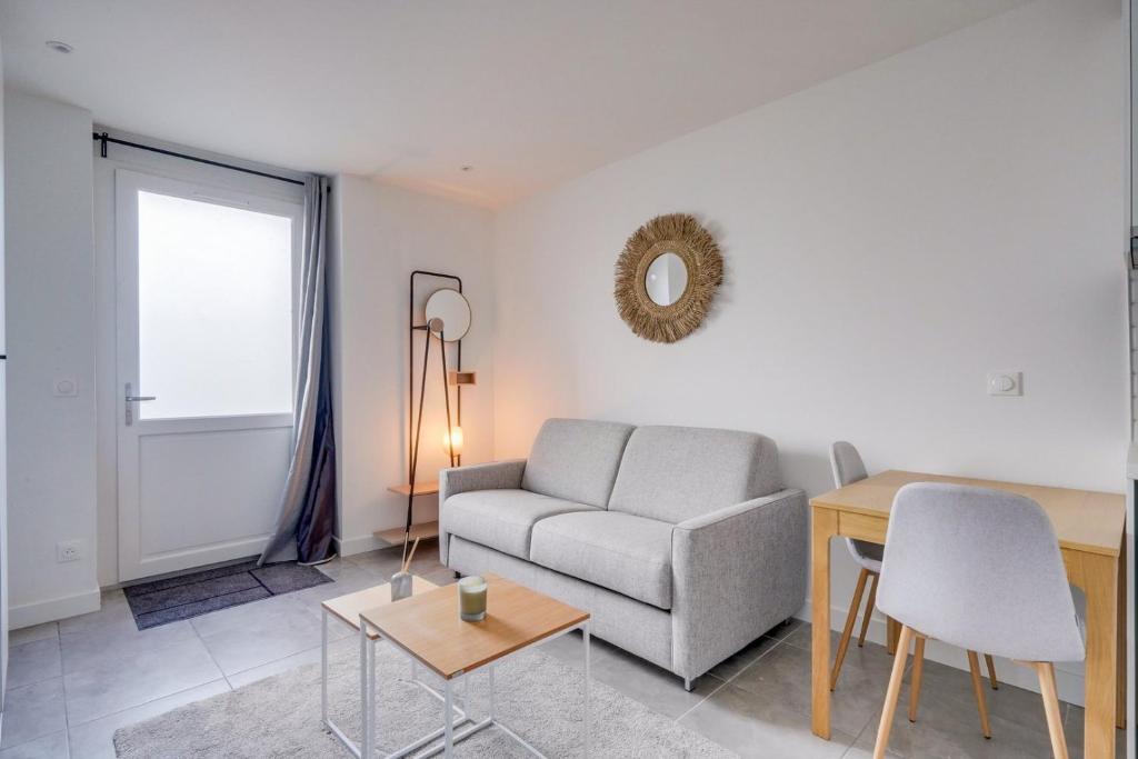 un salon avec un canapé et une table dans l'établissement Superbe appartement sur les quais de Bordeaux, à Bordeaux