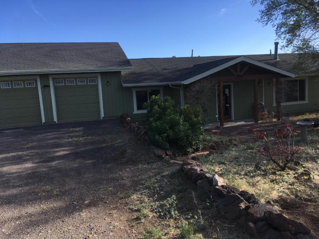 a house with a yard with a driveway at Peaks Wildernest House Bed and Breakfast - Vaccinations Required in Flagstaff