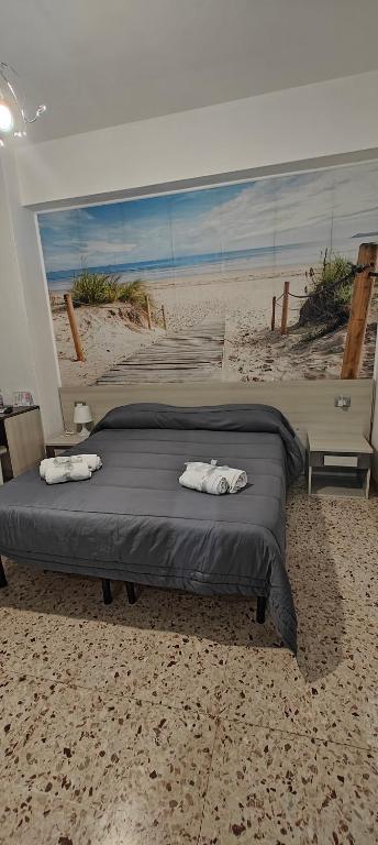 Postel nebo postele na pokoji v ubytování Nettuno Rooms