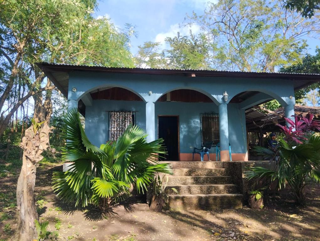 a blue house with a staircase leading to it at Rancho Belen in Isla de Ometepe